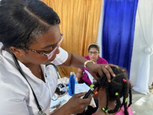 Doctor examining a young girl