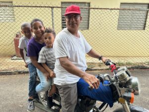 Family of four riding together on a motorcycle