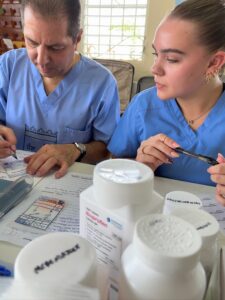 Two team members preparing medicine at a clinic