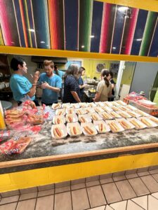 rows of hot dogs set out on the counter for kids dinner