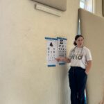 Nurse pointing to Eye chart on wall