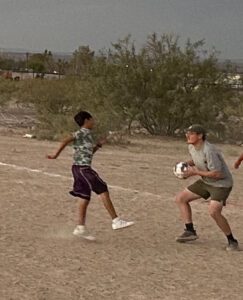 Two young men playing soccer