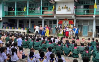 Many school children watching a drama presentatoin