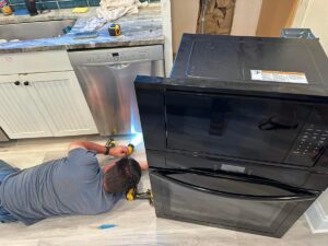 Man working to install an oven