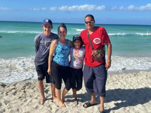 family standing together at the beach